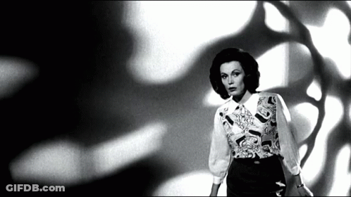Black And White Woman In Patterned Shirt GIF