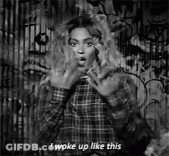 Black And White Woman In Plaid Shirt Making Face GIF