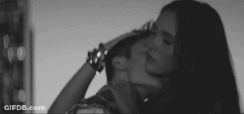 Black And White Woman Kissing Man's Neck GIF