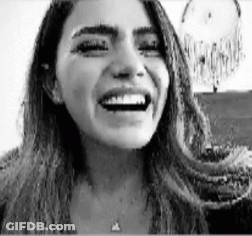 Black And White Woman Laughing By Dream Catcher GIF