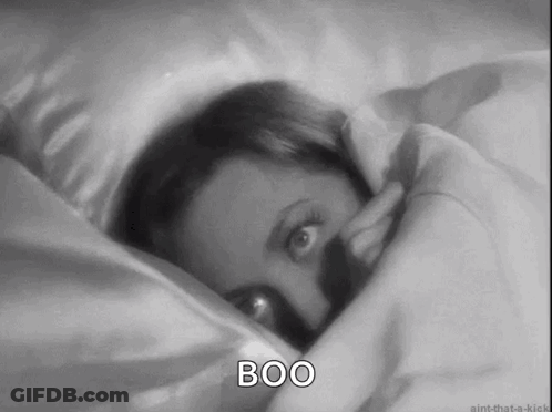 Black And White Woman Laying In Bed Saying Boo GIF