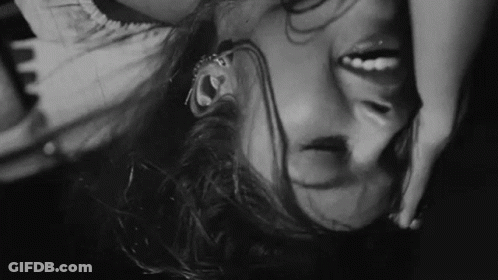 Black And White Woman Laying Upside Down Head In Air GIF