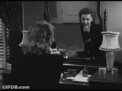 Black And White Woman Looking At Mirror Reflection GIF