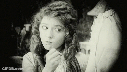Black And White Woman Looking In Mirror GIF