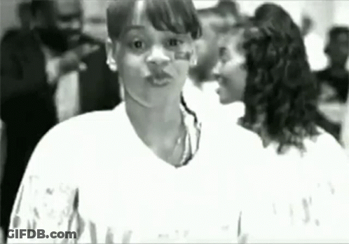 Black And White Woman Standing In Crowd GIF