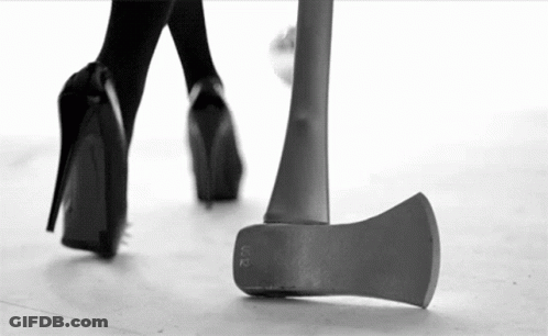 Black And White Woman Walking Next To Axe GIF