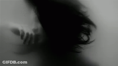 Black And White Woman With Hand Behind Her GIF