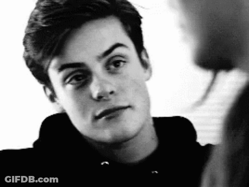 Black And White Young Man In Hoodie Looking At Camera GIF