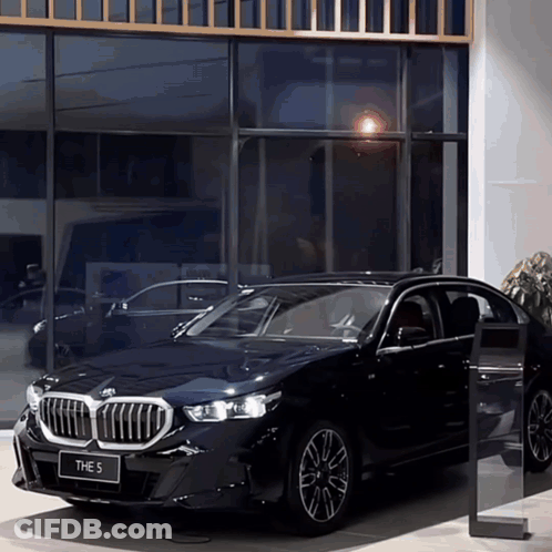 Black BMW 5 Parked In Front Of Building GIF