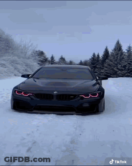 Black BMW Driving In Snow GIF