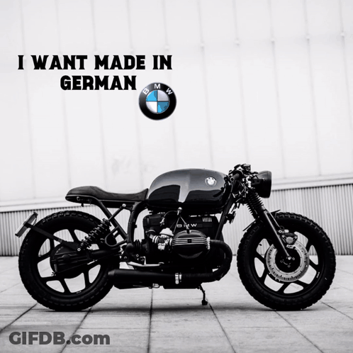 Black BMW Motorcycle In Front Of BMW Logo GIF