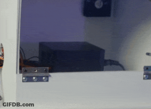 Black Box Behind Glass Door With Purple Light GIF