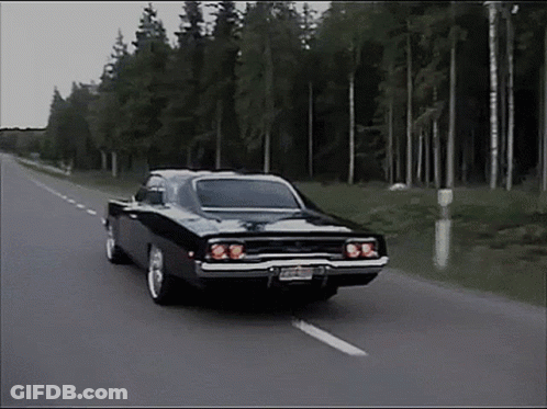 Black Car Driving Down Road With Trees GIF