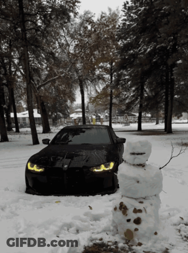 Black Car Parked In Snow With Snowman GIF