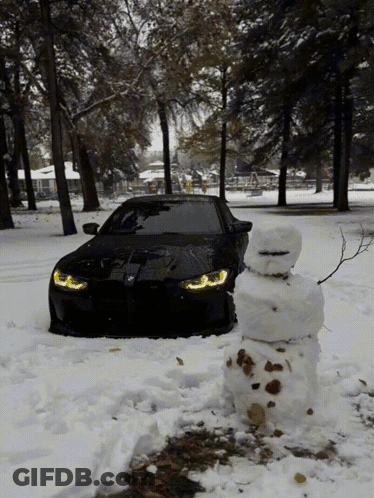 Black Car Parked Next To Snowman GIF