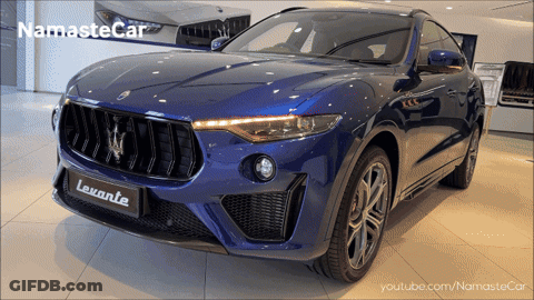 Black Car With Letter M Driving Down Road GIF