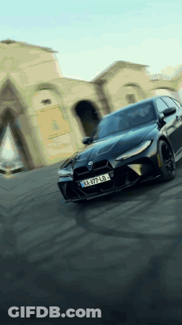 Black Car With License Plate KA-977-LO Driving Down Street GIF
