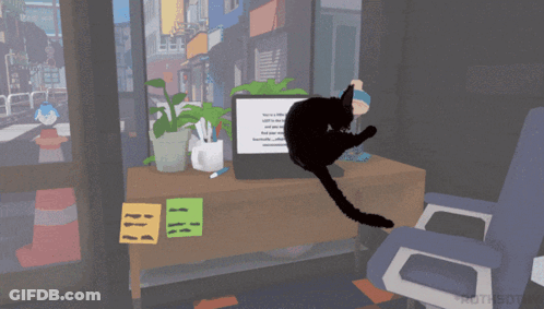 Black Cat Sitting At Computer Desk GIF