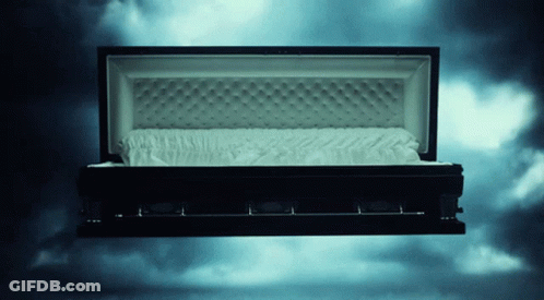 Black Coffin With Open Lid And White Blanket GIF