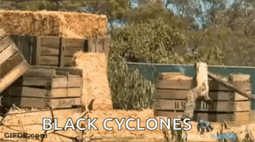 Black Cyclones Sign In Front Of Hay Pile GIF