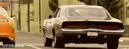 Black Dodge Charger Driving Beside Red Car GIF