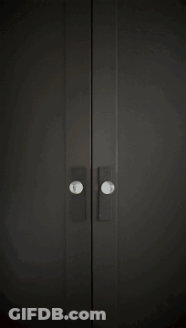 Black Door With White Sign Saying Mo GIF