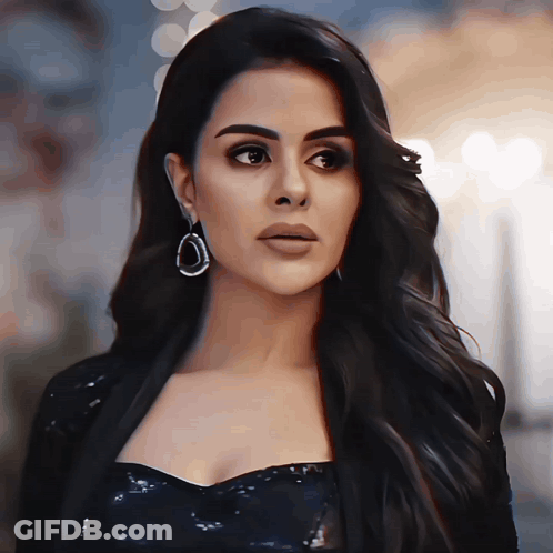 Black Dress Woman Looking At Camera With Earrings GIF