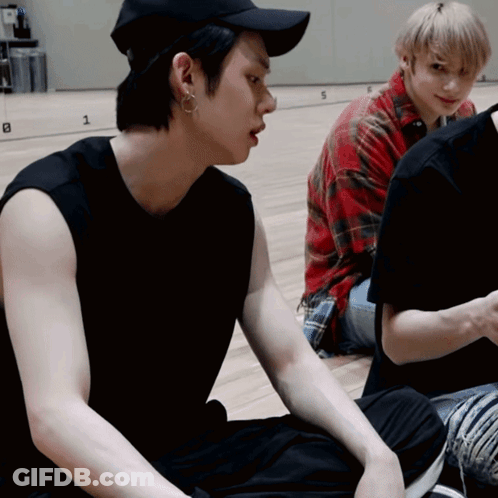 Black Hat Man Beside Red Plaid Man GIF