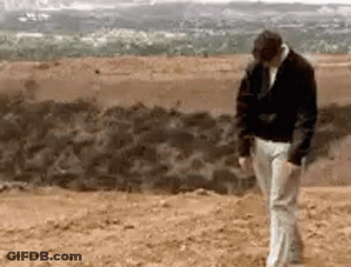 Black Jacket White Pants Man Standing In Desert GIF