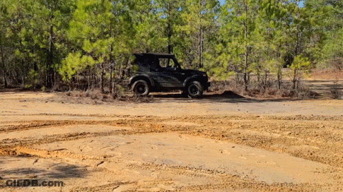 Black Jeep Driving Down Dirt Road GIF