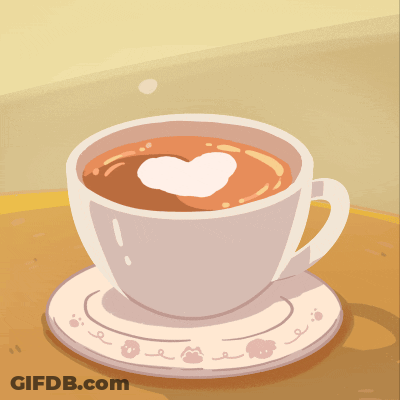 Black Kitten Sitting Next To Cup Of Coffee GIF