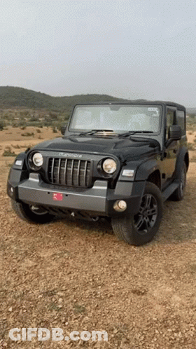 Black Mahindra Thar Jeep Parked On Dirt Field GIF