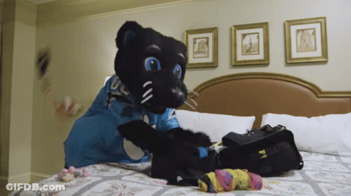 Black Panther Mascot On Bed With Bag GIF