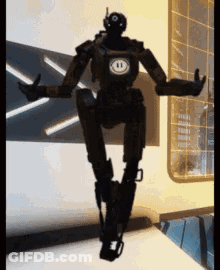 Black Robot With Smiley Face On Chest GIF
