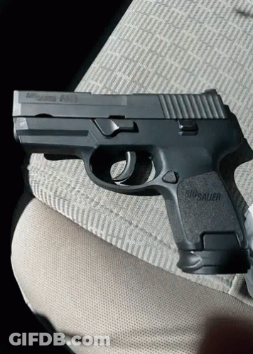 Black Sig Sauer Pistol On Lap GIF
