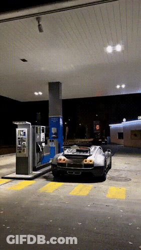 Black Sports Car Parked At Gas Station At Night GIF