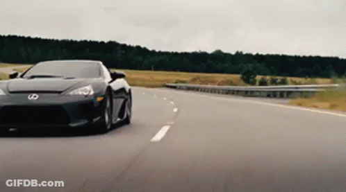 Black Sports Car With Letter S On Front Driving Down Highway GIF
