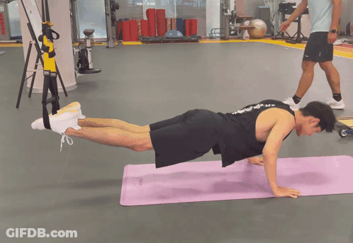 Black Tank Top Man Doing Push Ups On Purple Mat GIF