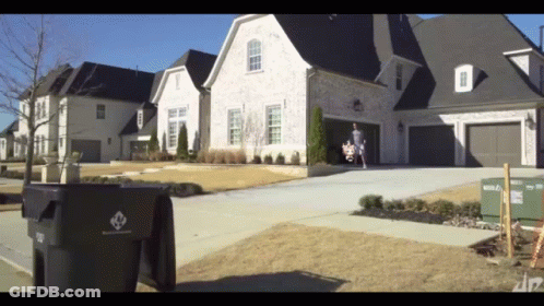Black Trash Can With Diamond Logo In Front Of House GIF