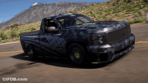 Black Truck Driving Down Road In Front Of Mountains GIF