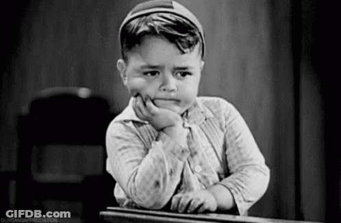 Black White Boy Sitting In Grass On Phone GIF