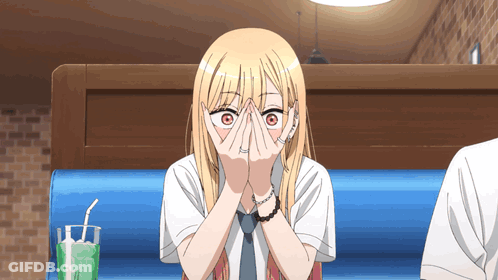 Blonde Anime Girl Covering Face In Diner GIF