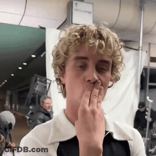 Blonde Curly Hair Man Covering Mouth GIF