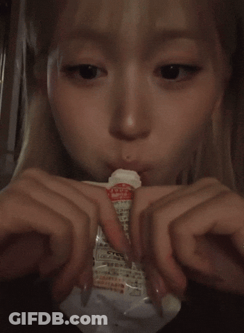 Blonde Girl Eating From Plastic Bag With Chinese Writing GIF