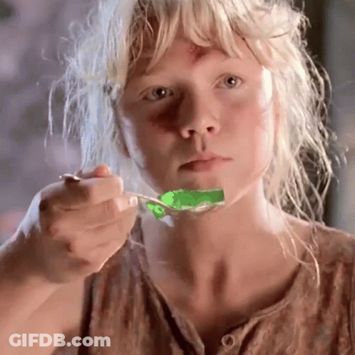 Blonde Girl Eating Green Jelly With Spoon GIF