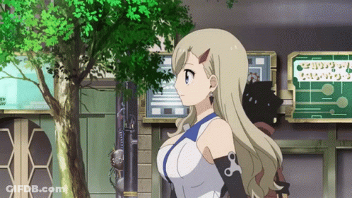 Blonde Girl In Front Of Building With I Love You Sign GIF