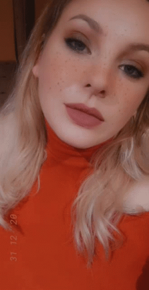 Blonde Girl In Red Dress Rolls Eyes GIF