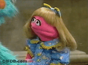 Blonde-Haired Pink Puppet In Blue Dress Next To Blue Puppet GIF