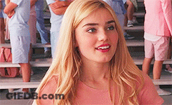 Blonde In Pink Shirt On Bench Facing Crowd GIF