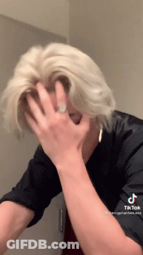 Blonde Man Covering Face With Ring On Hand GIF